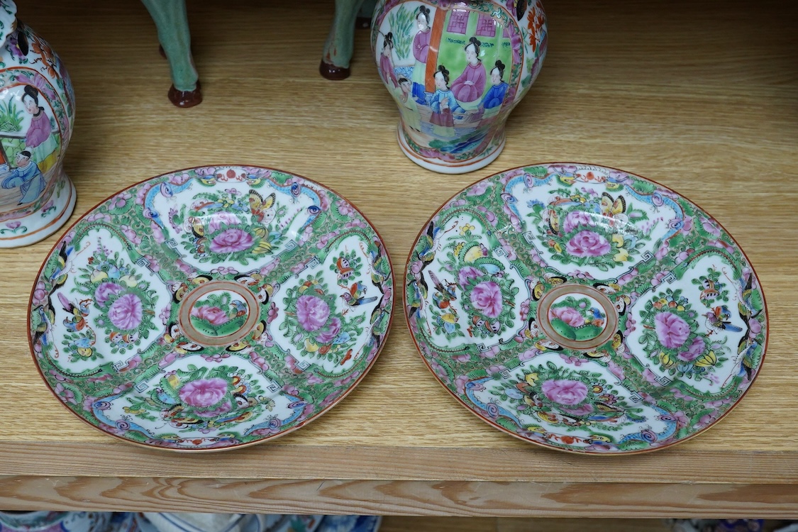 A pair of Chinese famille rose vases, two Canton plates and a green glazed horse, largest 29cm wide